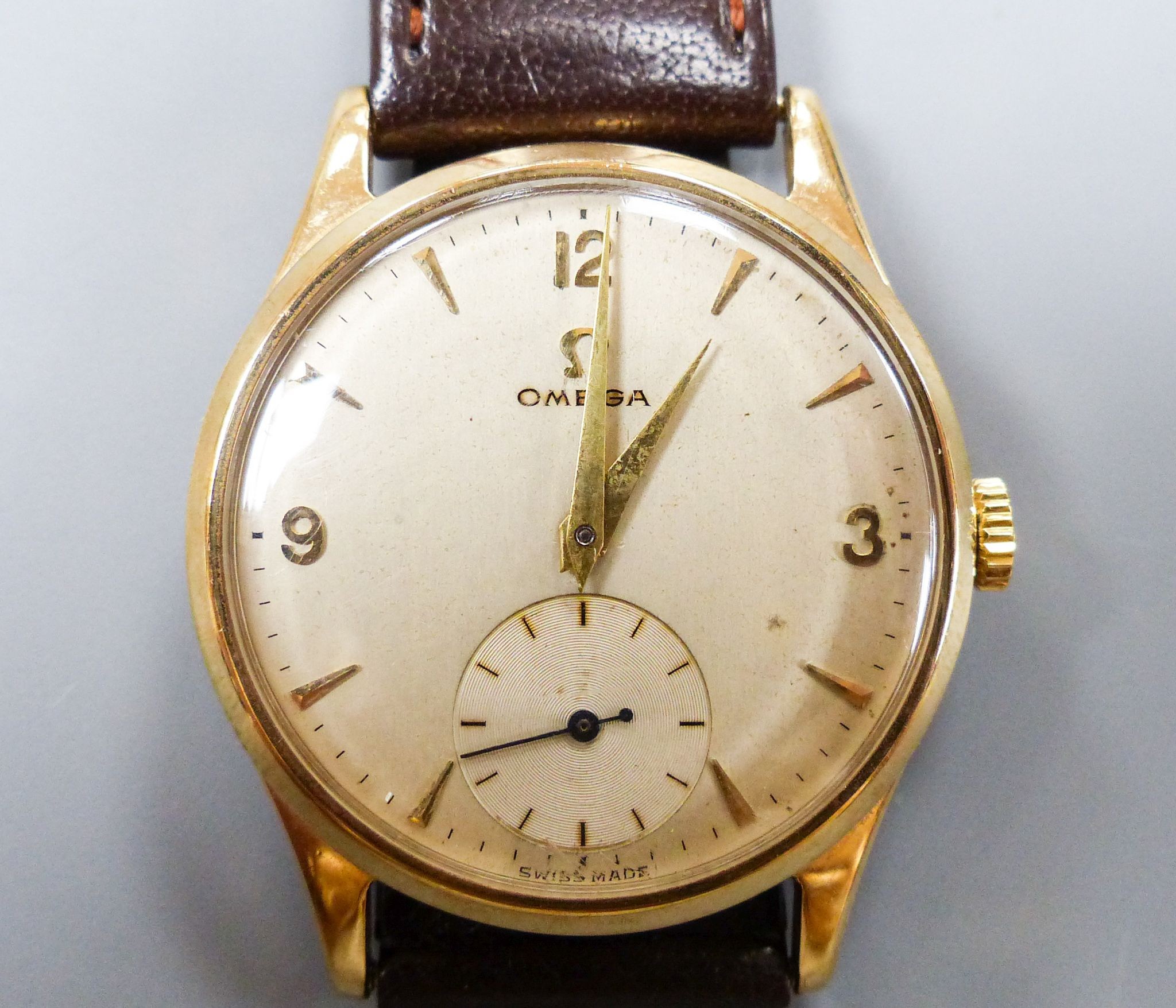 A gentleman's 1950's 9ct gold Omega manual wind wrist watch, movement c.266, on associated strap, cased diameter 33mm, gross weight 36 grams.